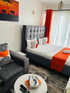 a living room with a bed and a couch at Tusmo homes in Ongata Rongai 