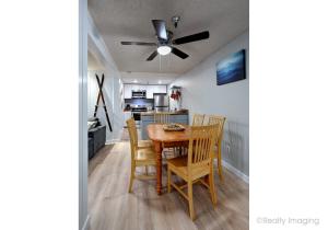 a kitchen and dining room with a table and chairs at Thunderhead Lodge Condo 204 - Modern Heated Pool & Games in Government Camp +23 photos
