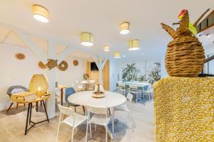 a room with a table and chairs and a couch at Ouest Découvertes in Crozon