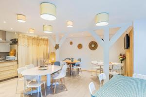 a kitchen and dining room with tables and chairs at Ouest Découvertes in Crozon +2 photos