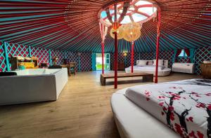 a room with a tent with two beds and a tub at Cortijo Boutique Marbella in Marbella +150 photos