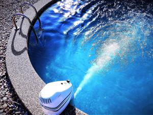 a pool of blue water with a object in it at Spa & Pool VILA ANNA in Halenkov