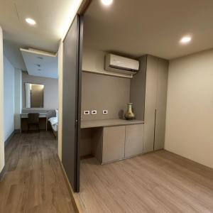 a room with a closet with a desk and a sink at Shin Mei B&B in Puli