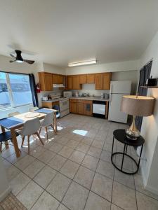 a kitchen with a table and chairs and a refrigerator at Spring Training Special Comfy 3 Bedroom in Phoenix
