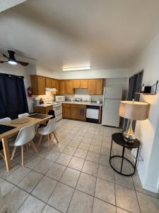 a kitchen with a table and a table and chairs at Spring Training Special Comfy 3 Bedroom in Phoenix +22 photos