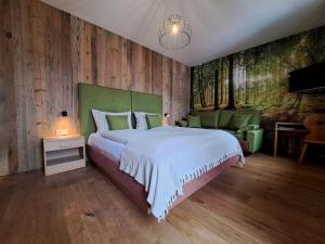 a bedroom with a large bed and wooden walls at B&B Brunnerhof in Feldthurns +16 photos