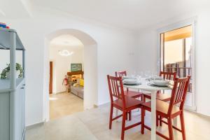 a dining room with a white table and chairs at La Casa sulla Cascata in Colonno