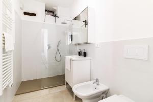 a white bathroom with a toilet and a shower at La Casa sulla Cascata in Colonno +41 photos
