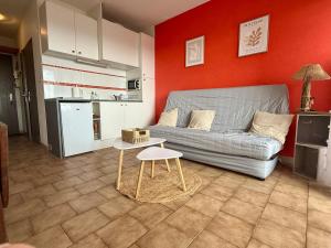 a living room with a couch and a table at Studio cabine première ligne in Fleury