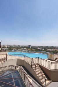 a view of a swimming pool with stairs on a building at Cozy Retreat Near Nairobi National Park, Giraffe Centre & Wilson Airport in Nairobi