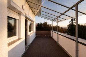 a balcony of a house with a view at Seeblick-Apartment am Bodensee bei Konstanz mit großer Terrasse in Reichenau +4 photos