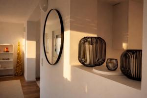 a room with two vases on a shelf with a mirror at Seeblick-Apartment am Bodensee bei Konstanz mit großer Terrasse in Reichenau