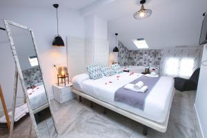 a bedroom with a large bed and a mirror at Apartamentos Cabañas in Carboneras de Guadazaón +75 photos