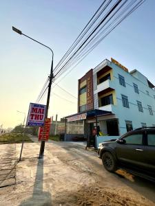 a car parked in front of a building with a sign at Motel Mai Thu in Thăng Bình