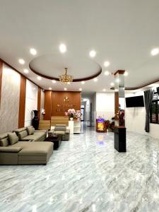 a lobby with couches and a television in a building at Motel Mai Thu in Thăng Bình