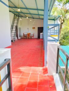 a room with a red tile floor and a staircase at CRUZ Palace in Jāmb