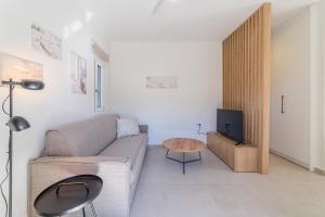 a living room with a couch and a table at Elia serenity apartment 4 in Mesochórion