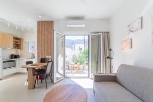 a living room with a couch and a table at Elia serenity apartment 4 in Mesochórion