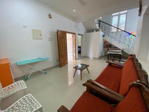 a living room with a red couch and stairs at CRUZ Palace in Jāmb