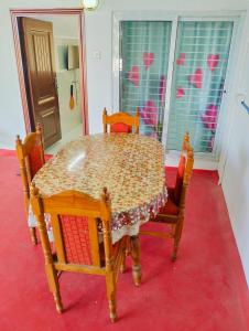 a dining room table with chairs and a table and a table and chairs at CRUZ Palace in Jāmb