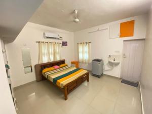 a bedroom with a bed and a toilet in it at CRUZ Palace in Jāmb