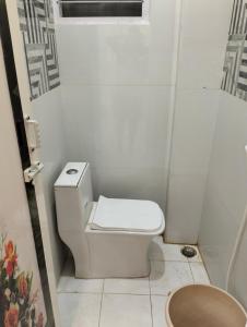 a small bathroom with a toilet and a window at CRUZ Palace in Jāmb +10 photos
