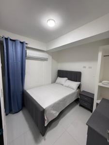 a bedroom with a bed with a blue curtain at Moon Apartamento C2 in San Cristóbal