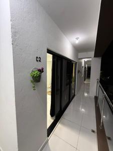 a hallway of a house with a plant on the wall at Moon Apartamento C2 in San Cristóbal