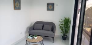 a gray chair sitting in a room with a table at Moon Apartamento C2 in San Cristóbal