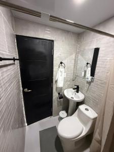 a bathroom with a white toilet and a sink at Moon Apartamento C2 in San Cristóbal