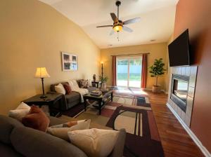 a living room with a couch and a fireplace at Charming Ranch Retreat in Bear Delaware in Bear