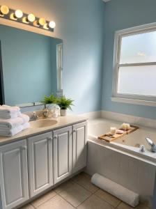 a bathroom with a sink and a large mirror at Charming Ranch Retreat in Bear Delaware in Bear