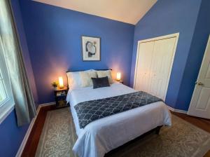 a blue bedroom with a bed and a white door at Charming Ranch Retreat in Bear Delaware in Bear +8 photos