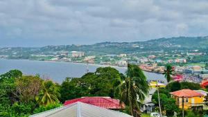 a view of a city and a body of water at Grandvistasuites Tobago in Scarborough