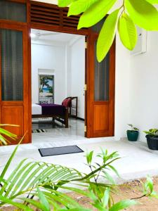 an open door to a room with a bed at Bluebell Guest House in Unawatuna
