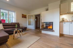 a living room with a couch and a fireplace at Winemakers Escape in Gleisdorf