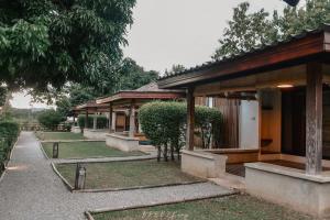 a row of buildings with trees in front of them at Chiangrai Ryokan in Ban Long Khi Na