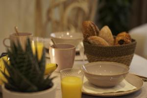 a table with a bowl of bread and a basket of orange juice at Cozy apartment in Irrel in Irrel