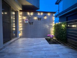 a garage door with lights on the side of a house at Summer Studio in Constanţa