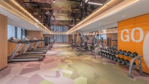 a gym with rows of treadmills and machines at EVEN Hotel Xi'an High-Tech Zone by IHG in Xi'an