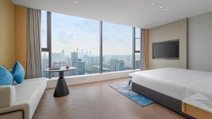 a hotel room with a bed and a large window at EVEN Hotel Xi'an High-Tech Zone by IHG in Xi'an +56 photos