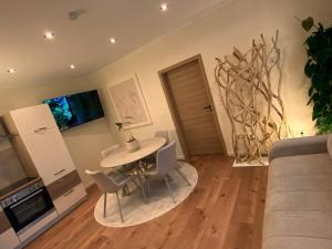 a living room with a table and chairs at Cozy apartment in Irrel in Irrel