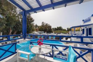 a balcony with a table and chairs and a pool at Samson΄s Village in Perissa