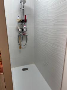 a bathroom with a shower with a glass door at Chambre chaleureuse in Grosley-sur-Risle +11 photos