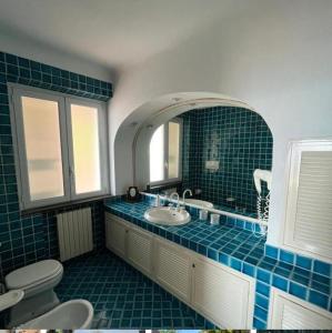 a bathroom with a sink and a toilet and a mirror at Villa Abelarda in Casamicciola Terme +131 photos