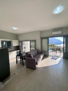 a living room with a couch and a table at Three Olive Homes in Kalymnos