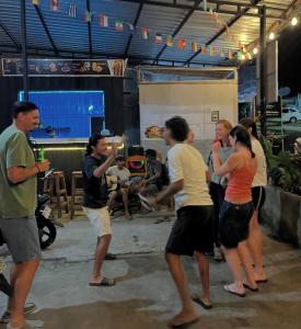 a group of people standing around in a room at jungle senaru cottage in Senaru