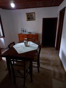 a dining room with a table and chairs and a desk at Casa Roberta in Martis