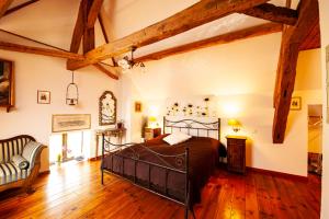 a bedroom with a large bed in a room with wooden floors at Manoir-de-Sagy in Sagy +35 photos
