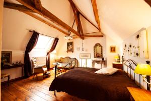 a bedroom with a large bed and a table and chairs at Manoir-de-Sagy in Sagy